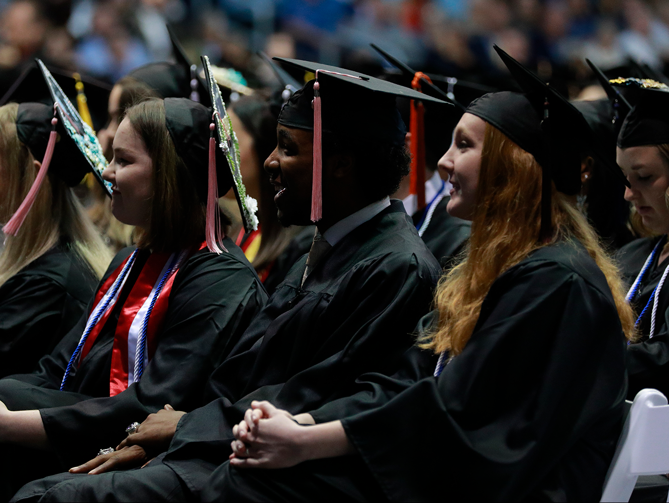 students wearing caps and gowns at commencement